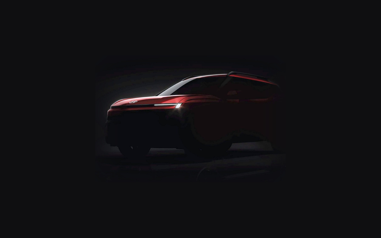 Teaser do novo Hyundai Bayon vermelho em vista dianteira de três quartos, com assinatura luminosa acesa