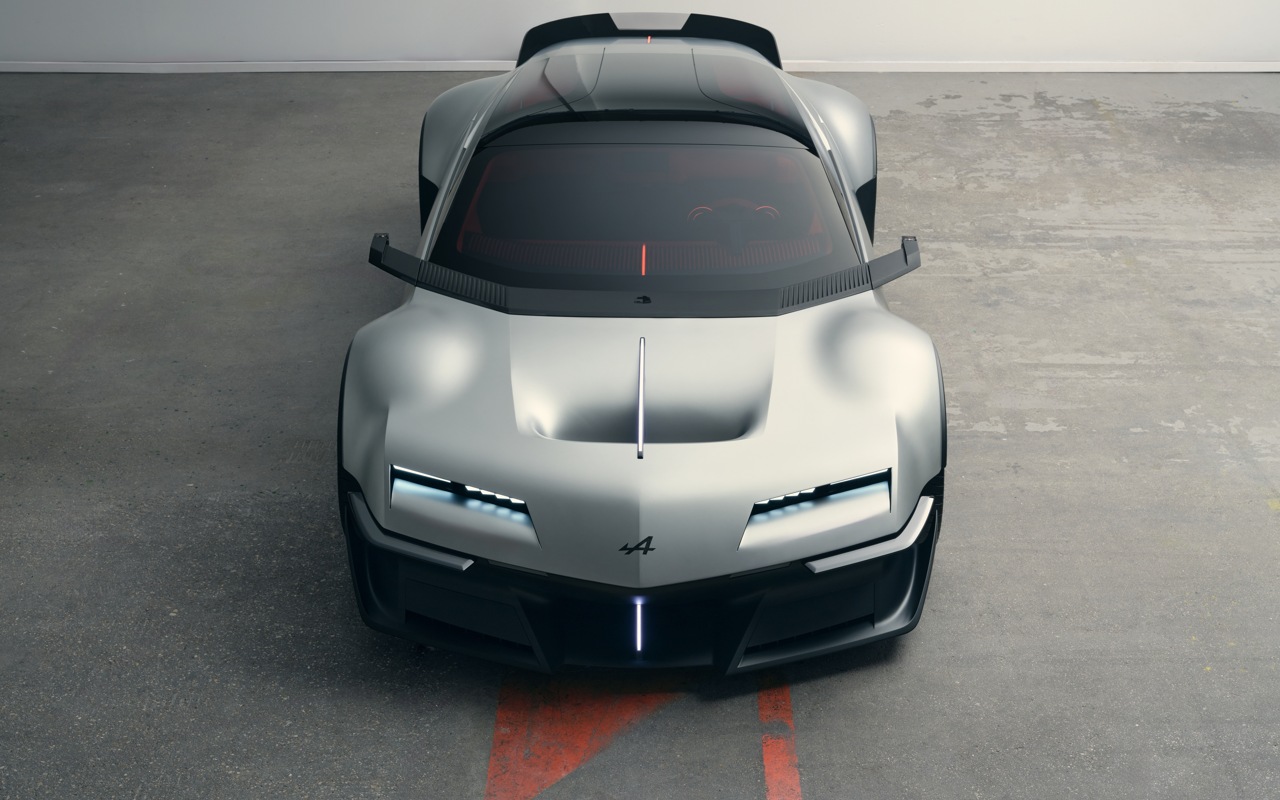 Alpine A310 VISION visto de frente e de cima, com faróis acesos